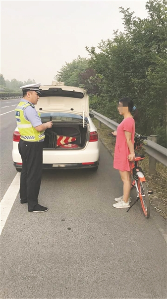 女子骑共享单车上高速回家被警察发现。