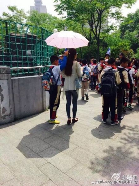 女老师让学生为其撑伞