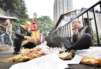 昨日，两路口到健康路的地下通道口，巫溪老人张家松摆摊卖山货，为2岁的白血病孙女挣药费。