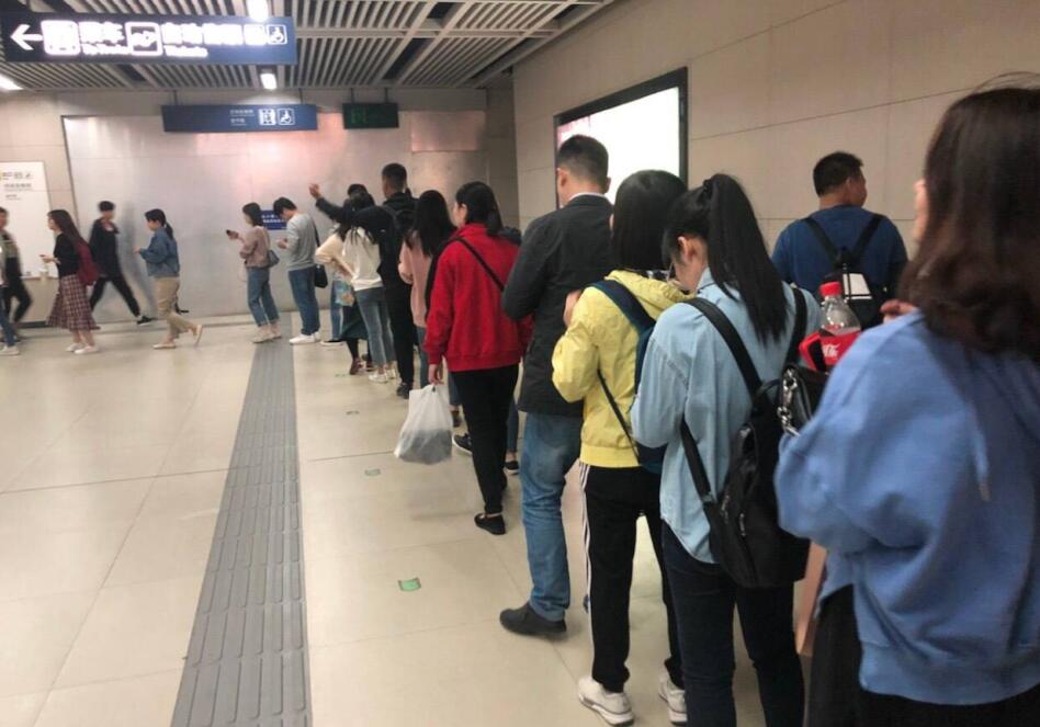 武汉地铁站内人流自动排“7”字形长队安检，路人拍摄视频点赞